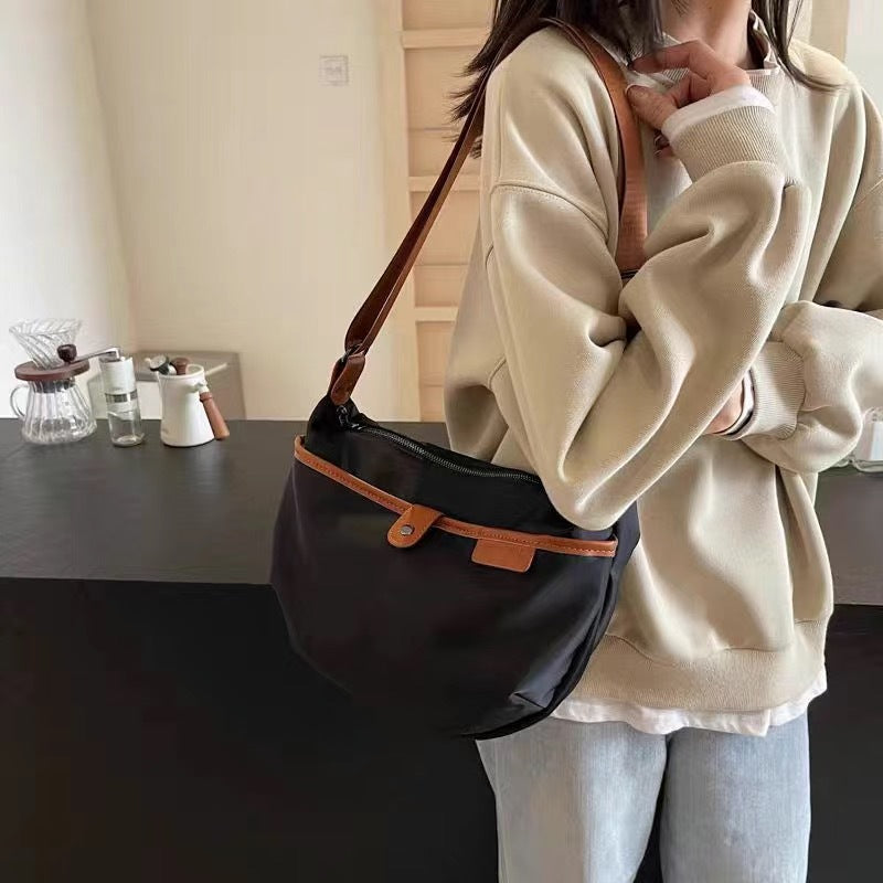 Nylon oxford cloth crossbody bag zipper detail - secure closure