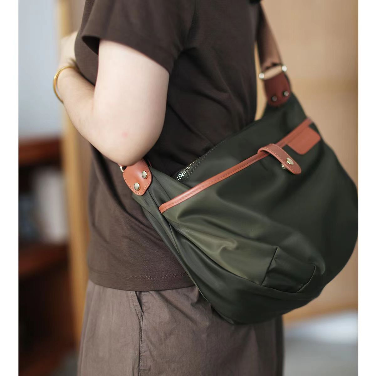 Nylon oxford cloth crossbody bag worn front - practical daily carry