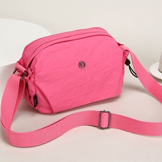 Women's nylon crossbody bag side view - saddle bag shape