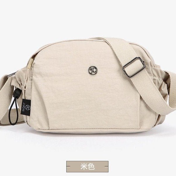 Women's nylon crossbody bag back view - adjustable strap